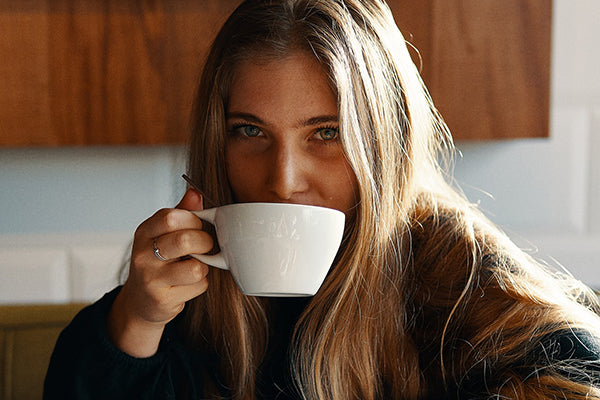 Why coffee is good for you: Lady sipping hot coffee from a white cup